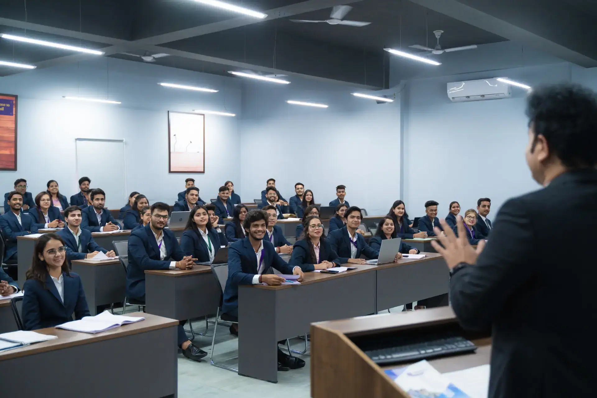 MBA students attending an interactive classroom session on AI education and modern business concepts, guided by a faculty instructor in a smart classroom.