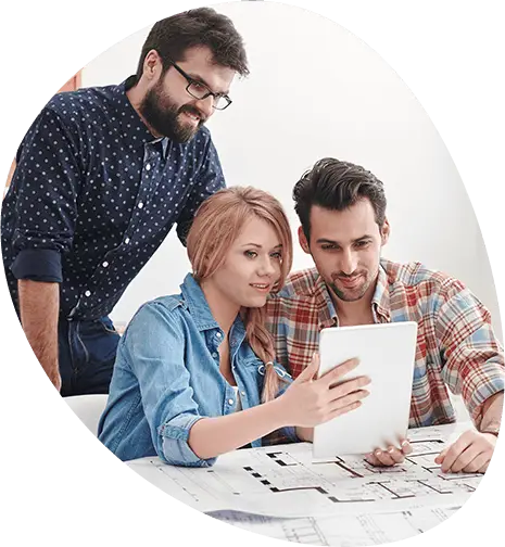 Group of students collaborating on a project using a tablet, representing teamwork and practical learning at top MBA colleges in Ahmedabad Gujarat.